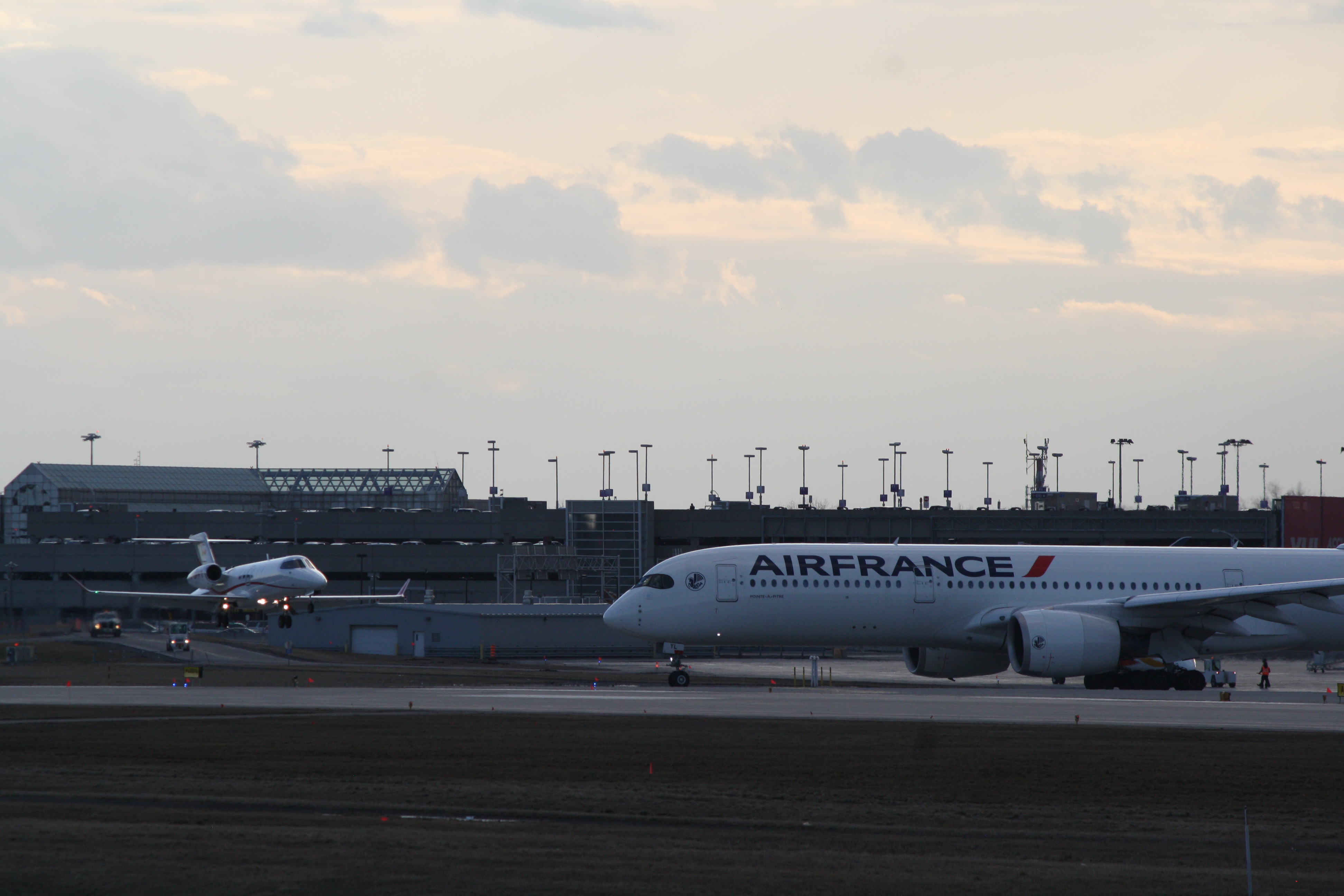 Big airplane waiting for small airplane